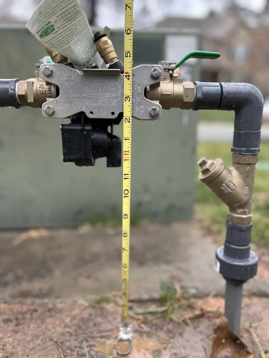 Backflow assembly being measured during field work